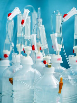 Plastic infusion sets clumped together with a blue backdrop